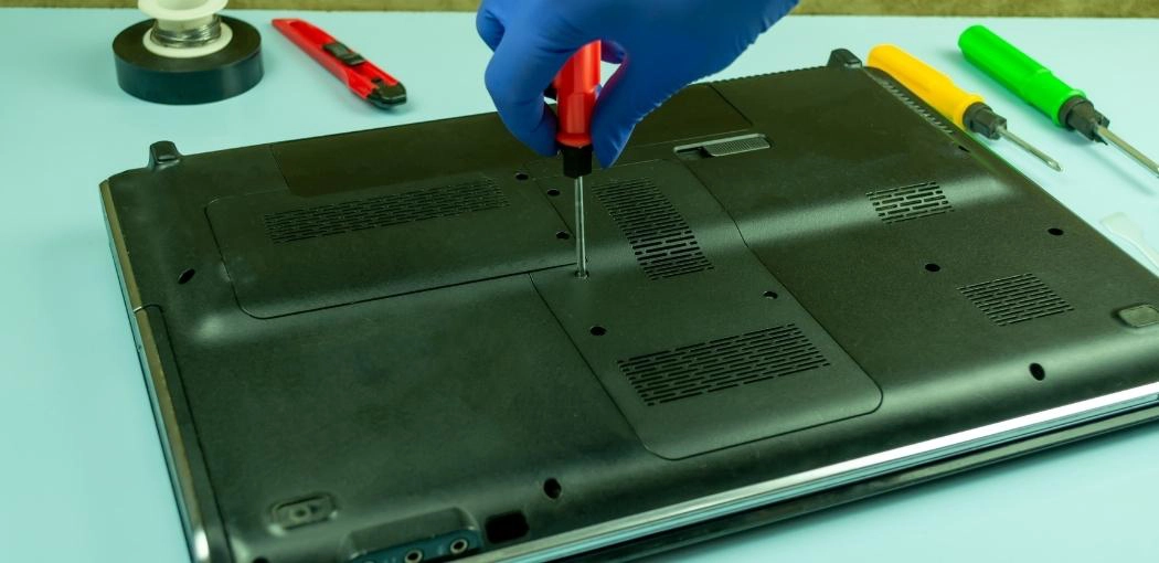 Step three: Remove the screws that are holding the cover of your laptop in place.