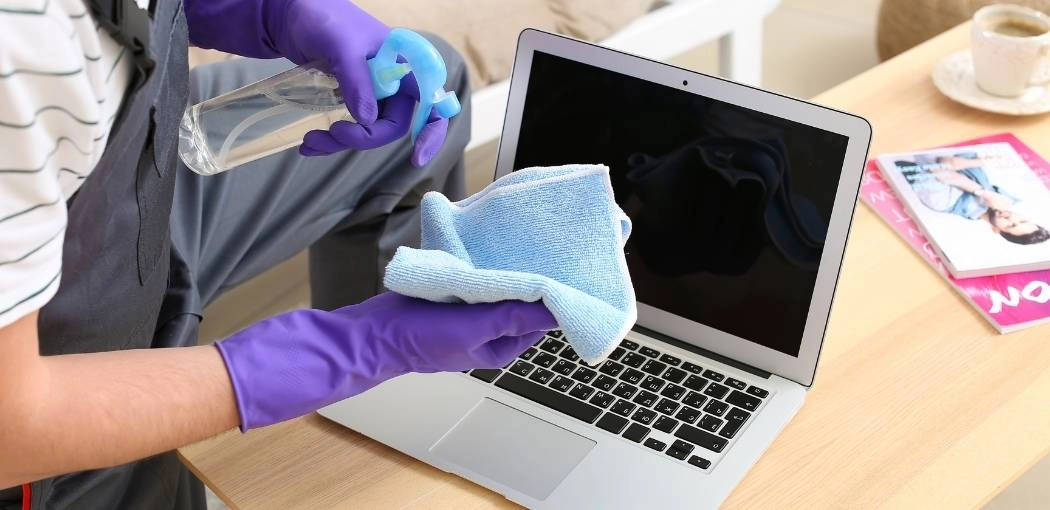 Can I use water to clean my laptop?